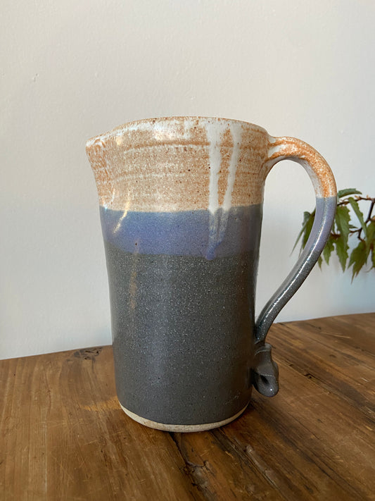 Tall glazed ceramic pitcher