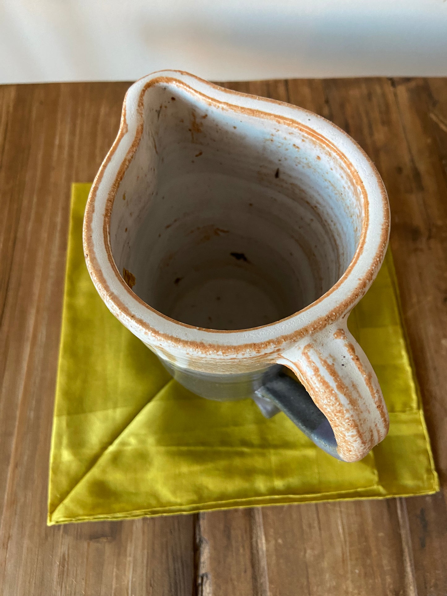 Tall glazed ceramic pitcher