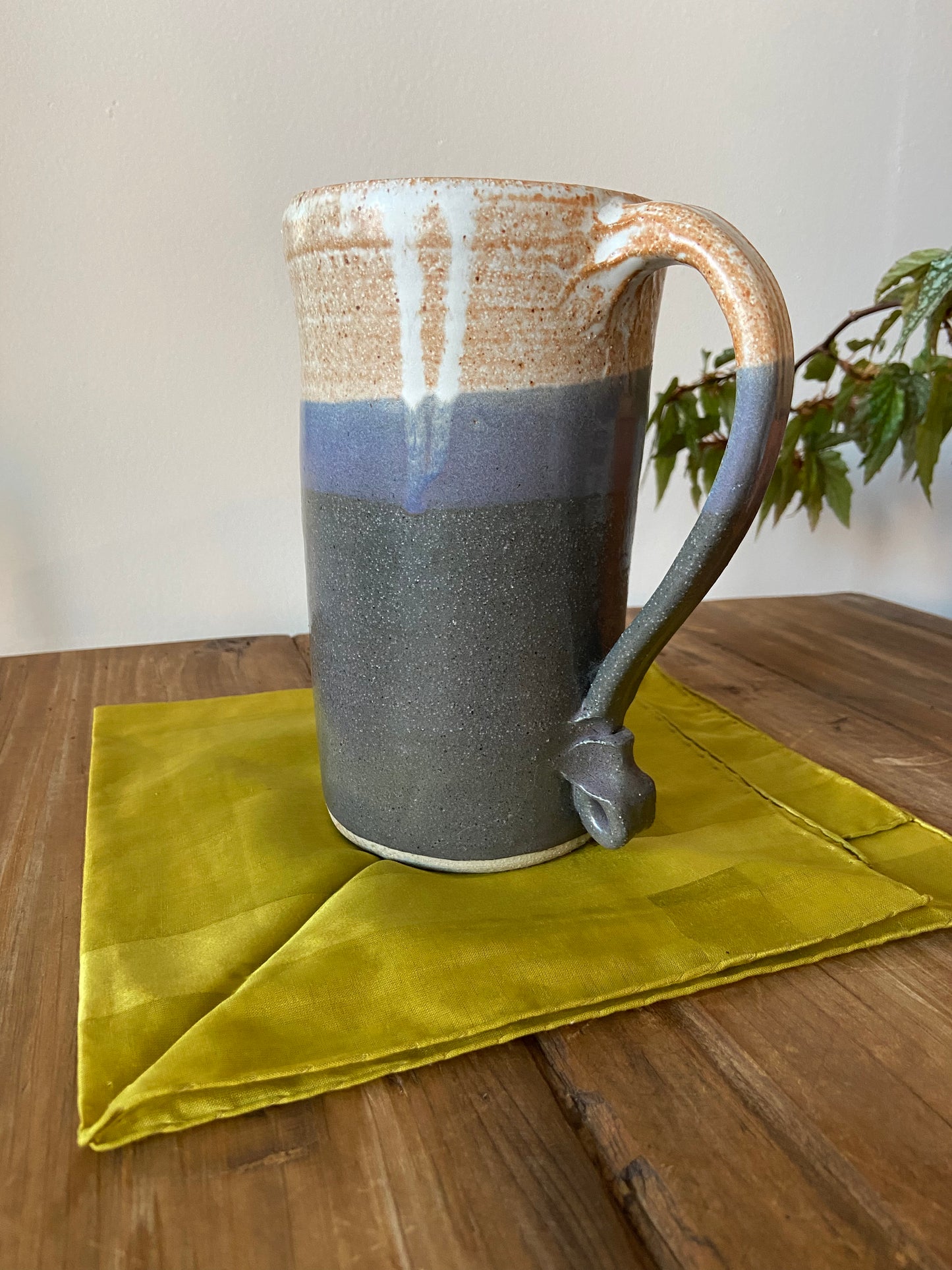 Tall glazed ceramic pitcher