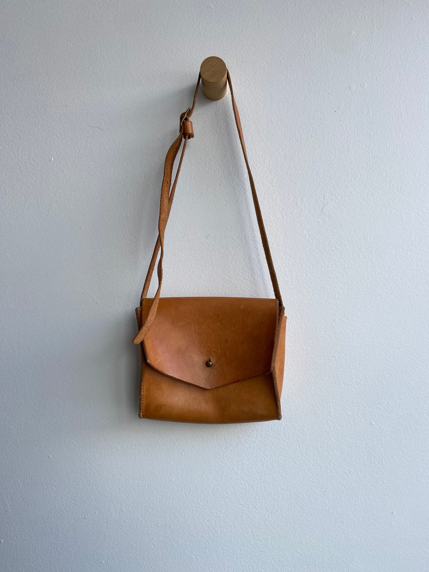 Warm brown leather purse with adjustable strap