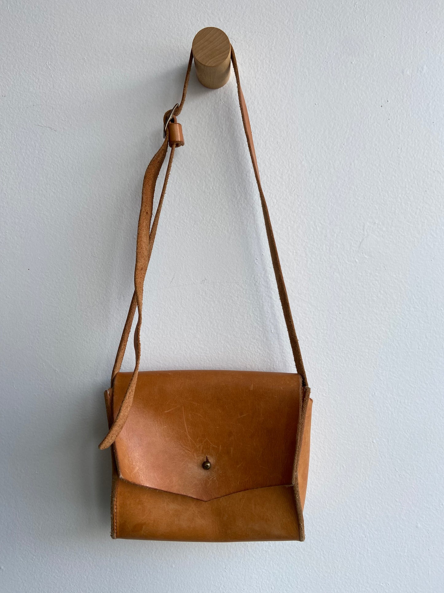 Warm brown leather purse with adjustable strap