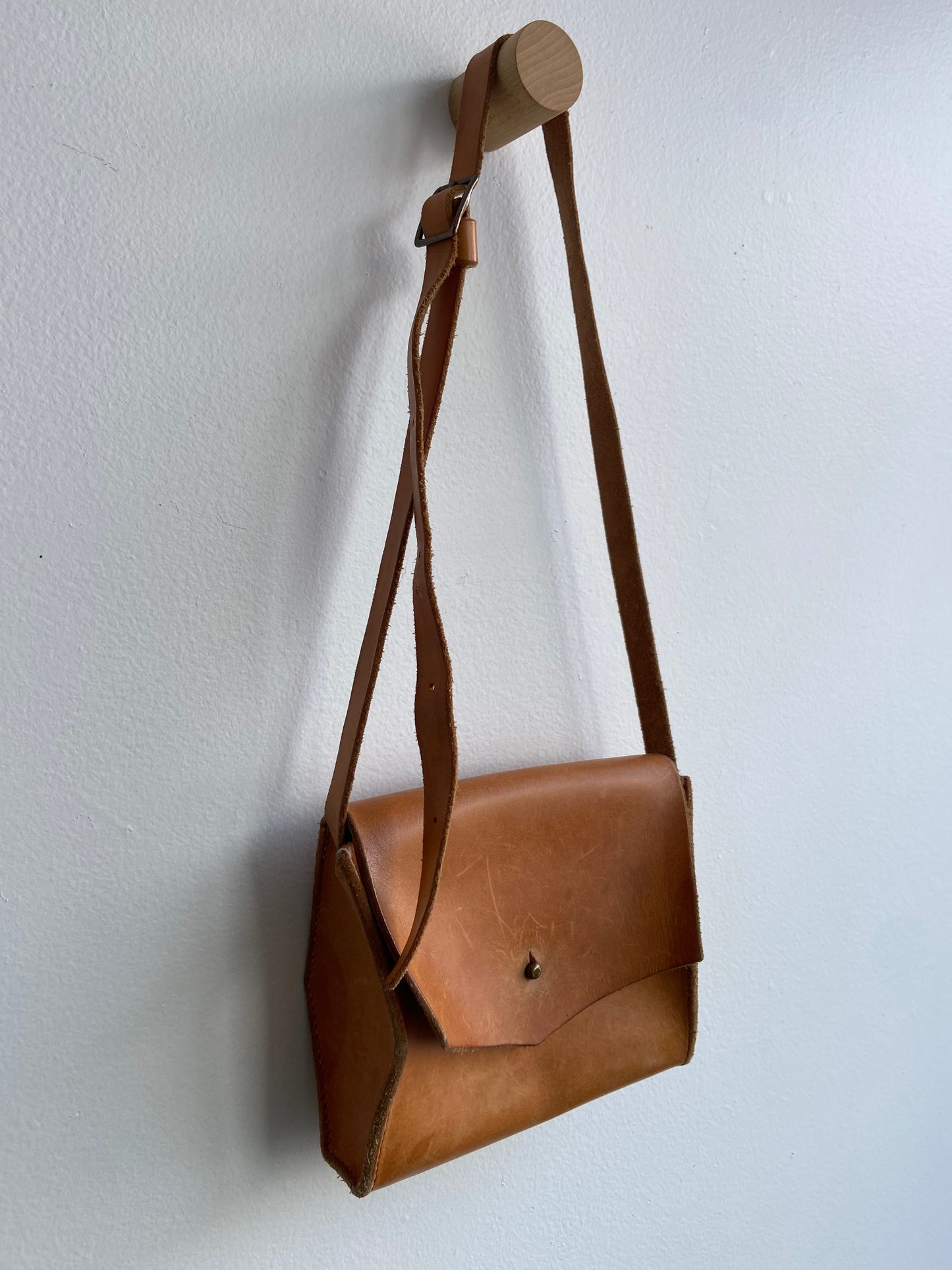 Warm brown leather purse with adjustable strap